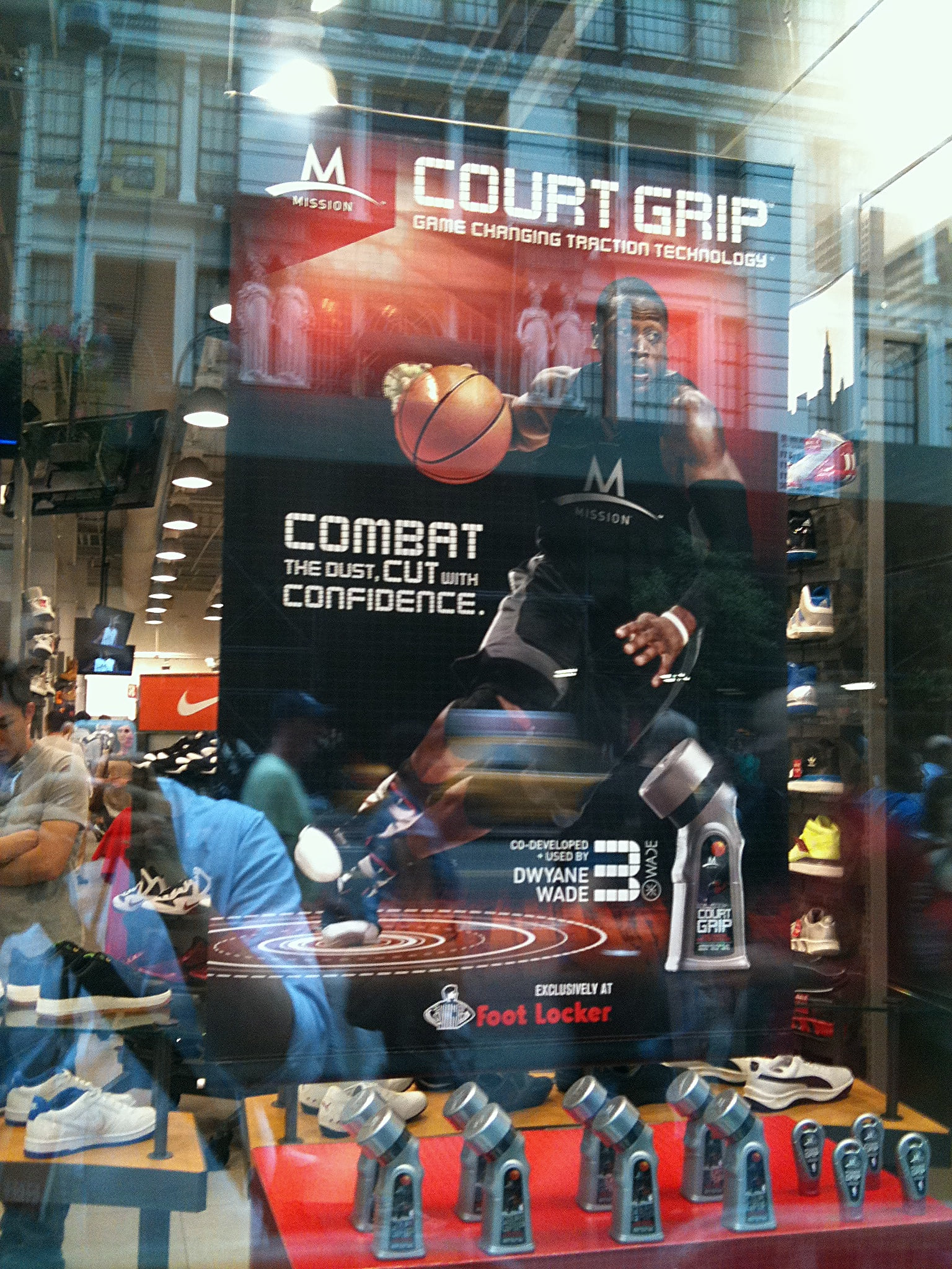 The window banner from the street, the building opposite reflected across it